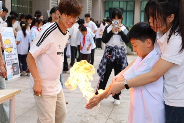 小朋友们在室外广场体验“火焰掌”实验。完美网页版供图 小朋友们在室外广场体验“火焰掌”实验。完美网页版供图